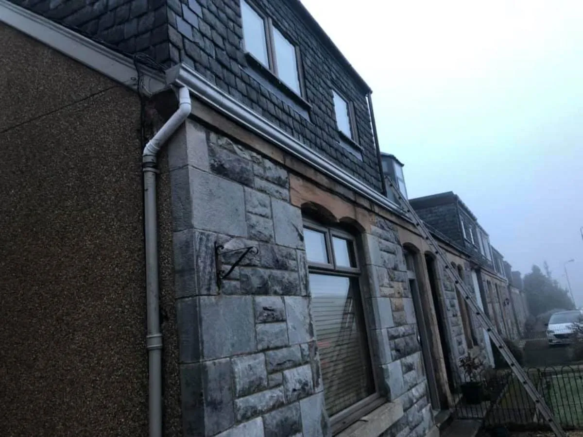 Completed slate roof and guttering on stone property in Forth Valley