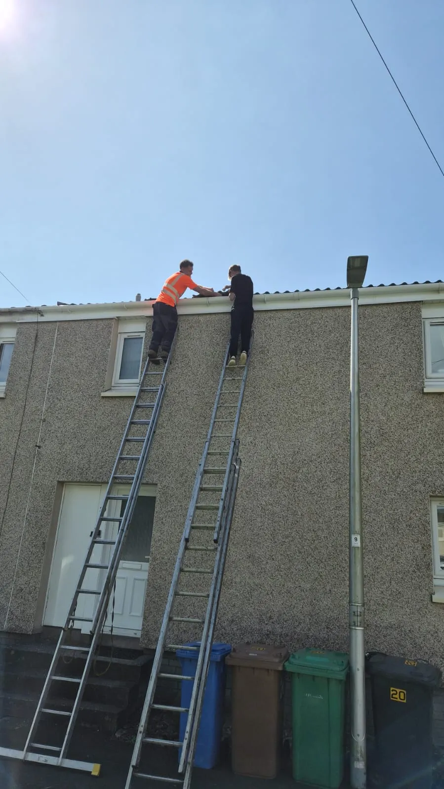 Gutter repair being carried out on a terraced house in Alloa