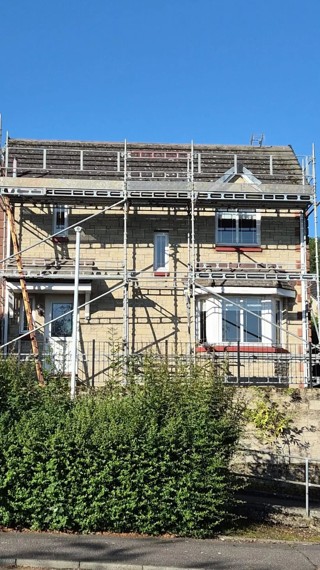 Front elevation of a Dalgety Bay house fully scaffolded with the old roof still in place