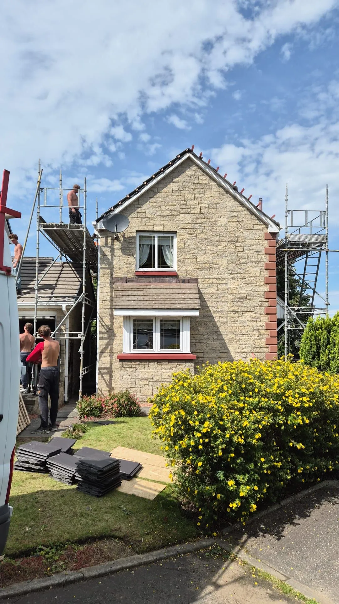New roof tiles stacked on site as the old covering is stripped from a house in Dalgety Bay