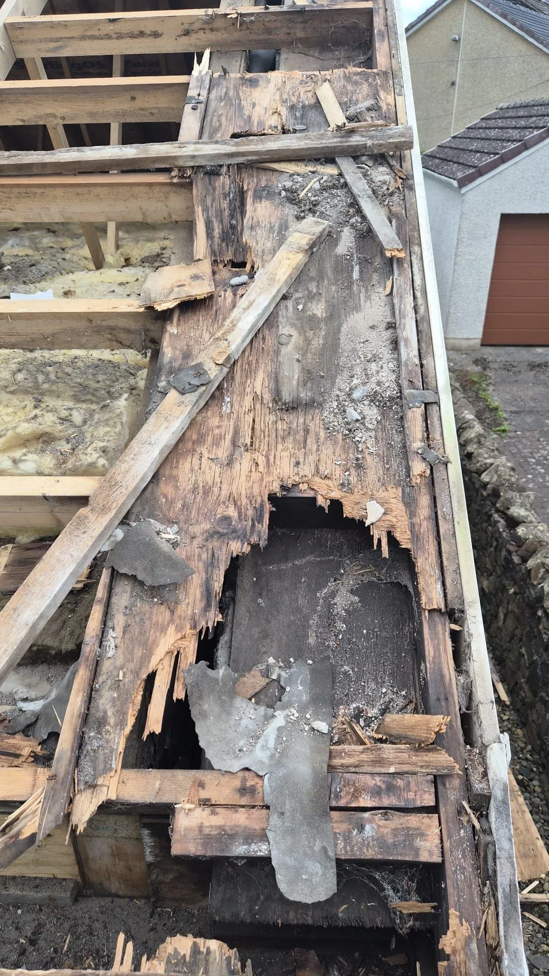 Rotten wallhead timber and decayed sarking exposed once the old roof covering was removed