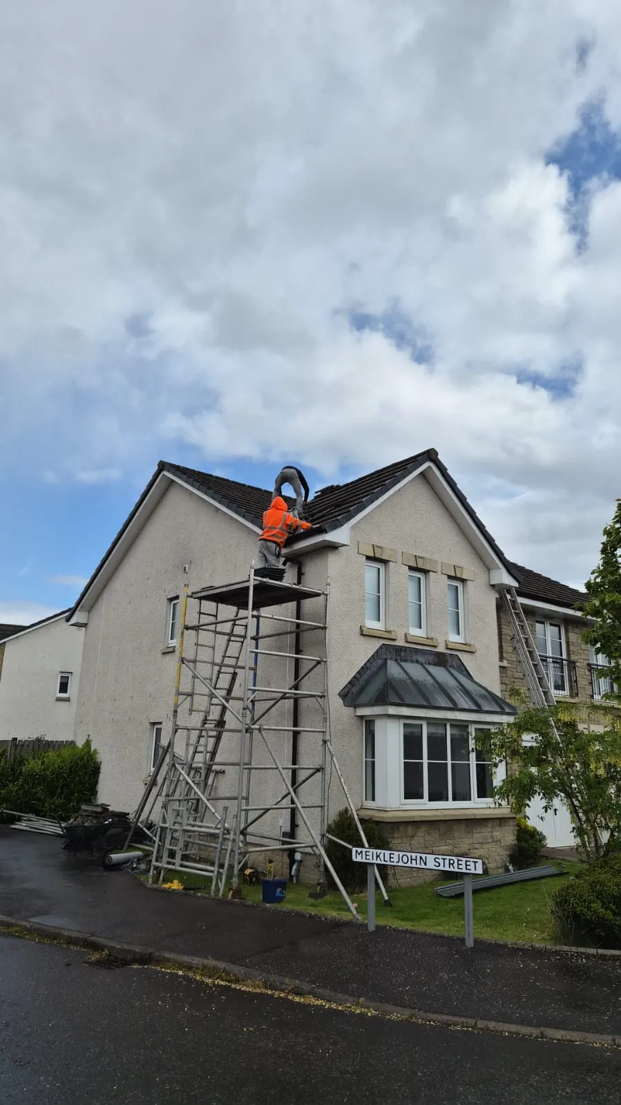 Ridge repair underway on a detached house roof in Alloa